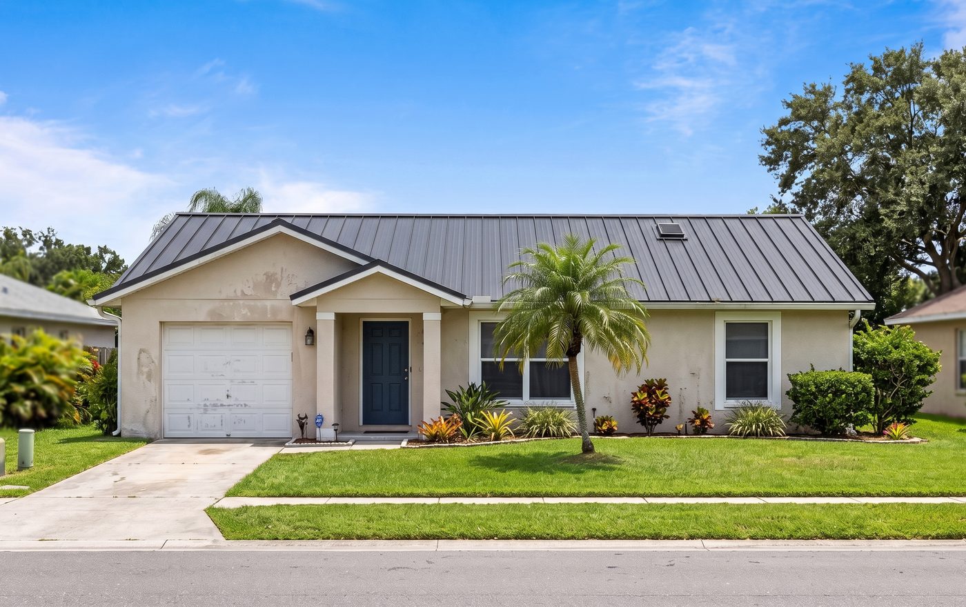 The same Florida home shown with an RPS standing seam metal roof.