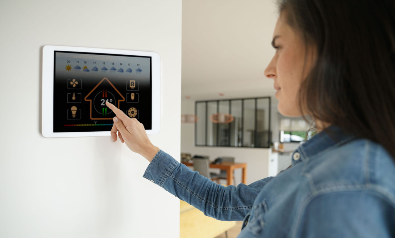 https://www.rpsmetalroofing.com/wp-content/uploads/2021/07/woman-adjusting-touchscreen-thermostat-1280x770.jpg