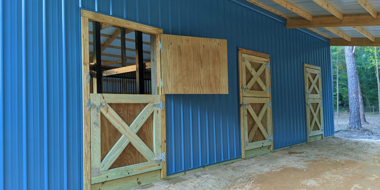 https://www.rpsmetalroofing.com/wp-content/uploads/2022/02/wooden-barn-doors-blue-metal-siding-1280x640.jpg