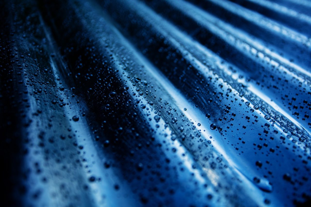 https://www.rpsmetalroofing.com/wp-content/uploads/2022/09/blue-metal-roof-panel-closeup-condensation-1280x853.jpg