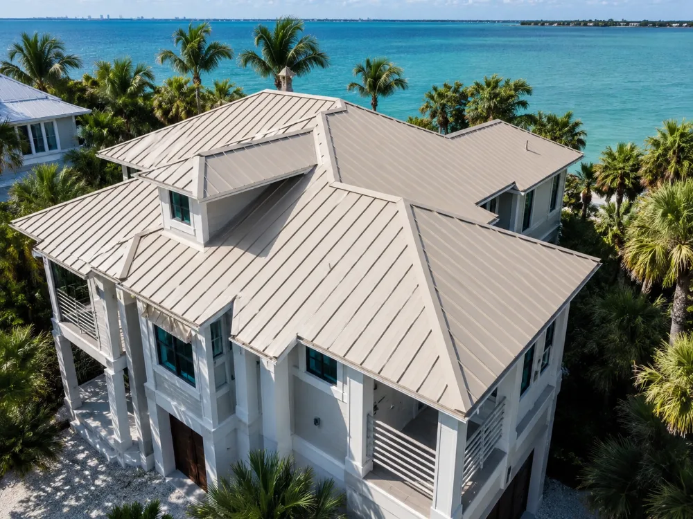 Bone white metal roof on a three-story coastal Florida house near the beach