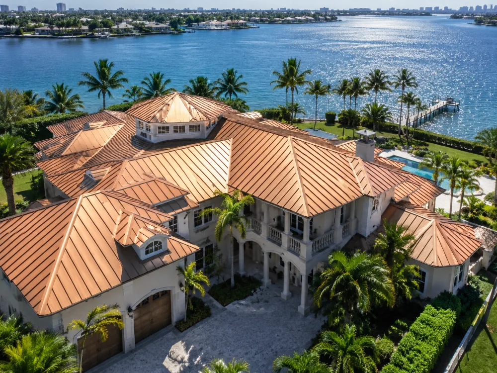 Copper-colored metal roof on a Florida waterfront estate with salt air exposure