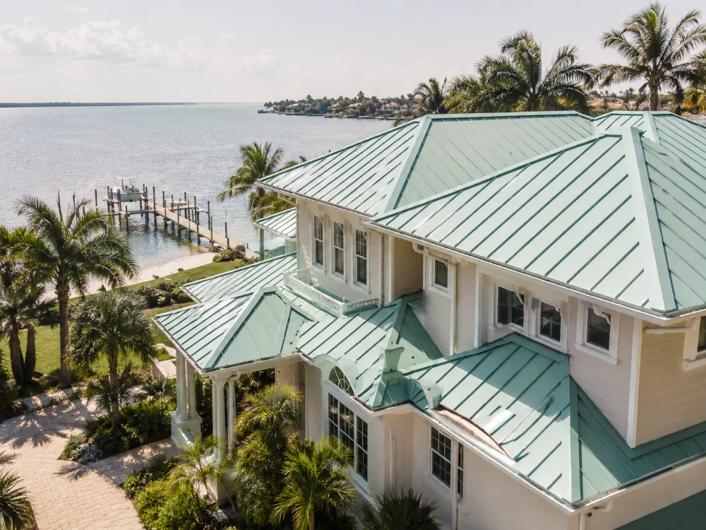 Teal standing seam metal roof on a coastal Florida home near the Intracoastal